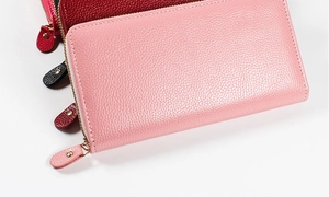 Macro shot of colorful pebbled leather long zip-around wallets with gold rivet details