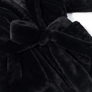 Close-up of soft black faux fur texture and waist belt detail on the padded coat