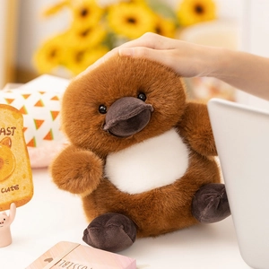Detail shot of soft plush platypus toy featuring brown faux fur and a fuzzy beak texture