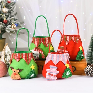 Detailed close-up of felt Christmas gift bags with snowman and elk embroidery appliques
