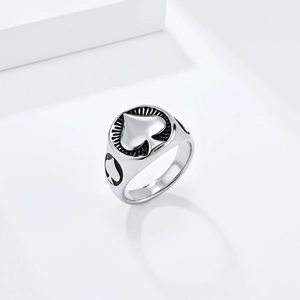 Macro shot of silver titanium spade ring with embossed details and textured surface