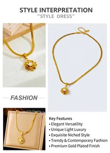 Macro shot of 3D gold lotus pendant with white pearl on sleek snake chain necklace