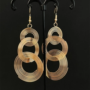 Gold multi-layered spiral hoop earrings with elegant geometric concentric circle design
