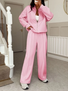 Detail of pink two-piece casual tracksuit with zip-up jacket and wide-leg trousers