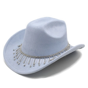 Gros plan d'un chapeau de cowboy en daim bleu clair avec détails de franges en strass