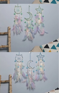 Detail of handmade dreamcatcher with LED lights, colorful feathers and soft pom-poms