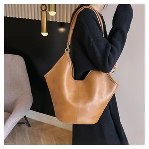 Close-up of caramel tote bag showing lychee grain leather texture and gold hardware