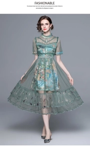 Detail of dark green mesh dress with embroidery, stand collar and ruffled lace trim