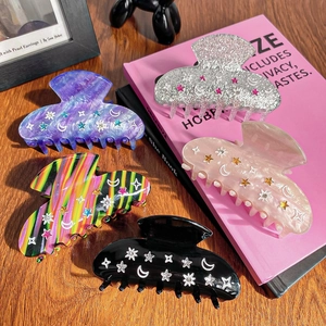 Set of 5 celestial hair claw clips featuring star and moon designs on various colors