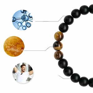 Tiger eye and matte black stone beaded energy bracelet with healing card on white background