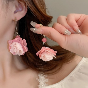 Detailed view of pink floral tassel earrings with silk petals and delicate beads