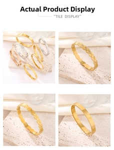 Macro view of assorted quilted and smooth metal bangles in gold and silver finishes