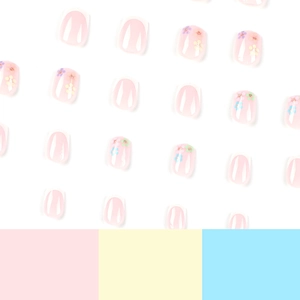 Short press on nails with white French tips and colorful floral designs on pink base