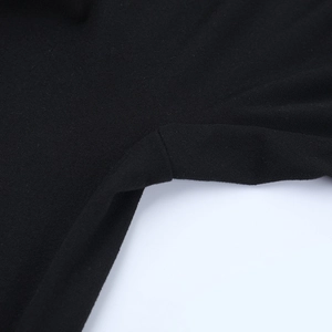 Detailed macro view showing the fine stitching and black knit fabric texture of the bodysuit