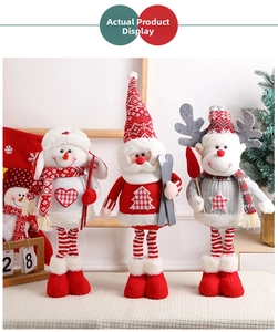Detailed view of plush Christmas dolls featuring snowman, Santa and reindeer with ski gear