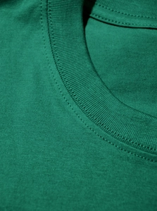 Detailed close-up of crew neck stitching and premium cotton texture of green t-shirt