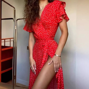 Red polka dot wrap dress with V-neck, ruffle sleeves and high slit for a vintage summer look