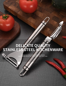 Dual stainless steel peelers on wooden board with fresh vegetables in kitchen setting