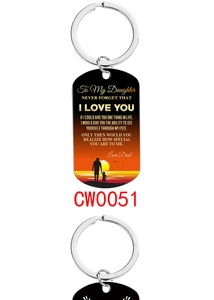 Detail of metal keychain featuring sunset silhouette and sentimental message for daughter