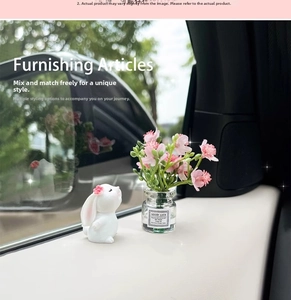 Miniature glass vase with pink flowers and a white resin bunny car dashboard ornament