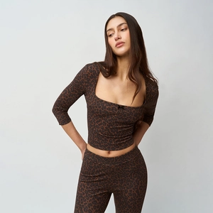 Detail view of stylish leopard print two-piece set with square neck top and leggings