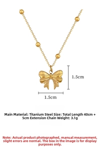 Detail of gold bow pendant necklace in titanium steel with beads chain dimensions