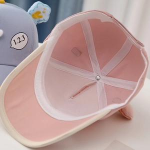Detail of baby baseball cap interior featuring breathable pink mesh lining and reinforced seams