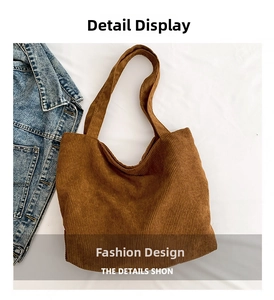 Detail shot of vintage coffee brown corduroy tote bag texture and soft shoulder strap