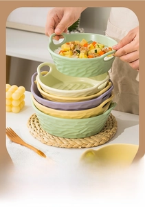 Detail view of double-handled ceramic bowls with handmade wavy texture in matte finish