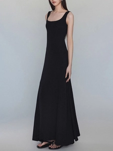 Full view of a slim fit black square neck sleeveless maxi dress with flip-flop sandals