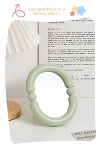 Detail of light green candy-colored oval vanity mirror with unique bubble frame design