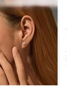 Detail of elegant S925 silver starfish earrings with small pearls on model's ear
