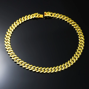 Polished golden cuban link necklace for men in a circular layout on black background