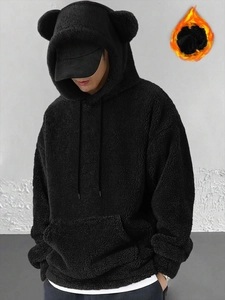 Detail of oversized black coral fleece hoodie featuring cute bear ears on the hood