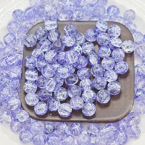 Macro detail of 10mm purple cracked glass beads for DIY jewelry making and crafts