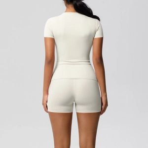 Rear view of cream-white short sleeve yoga set showing ergonomic fit and high-stretch fabric