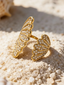 Detail of an 18k gold plated stainless steel open ring with sparkling pavé fan shapes
