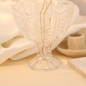 Elegant gold leaf necklace with pink marquise gemstone and white cubic zirconia accents
