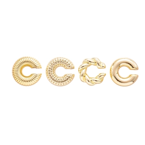 Set of four gold-plated metal ear cuffs with twisted and textured patterns for women