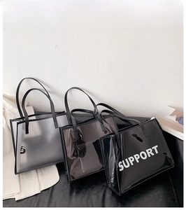 Three transparent PVC tote bags with SUPPORT text in clear, smoky grey, and black colors