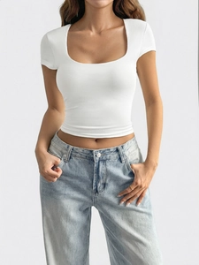 Detailed view of white slim fit U-neck short sleeve T-shirt styled with blue jeans