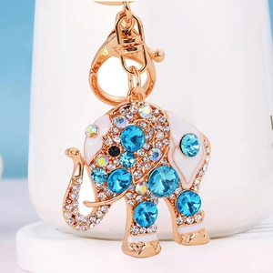 Macro view of crystal-encrusted elephant keychain with white enamel and blue rhinestones