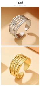 Detail showing gold and silver multi-layer intertwined stainless steel open rings