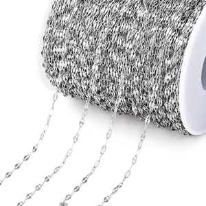 Close-up of silver stainless steel chain links on white spool for DIY jewelry making