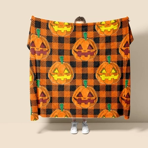 Halloween flannel blanket featuring cartoon pumpkins on black and orange checkered pattern