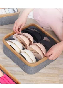 Detail of bamboo framed organizer with grey fabric dividers for bras and socks