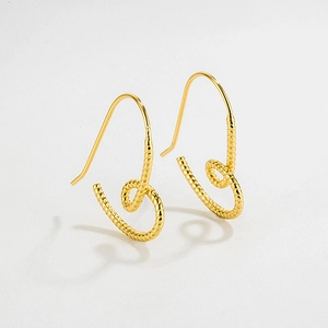 Close-up of gold spiral drop earrings featuring detailed ribbed texture and hook design