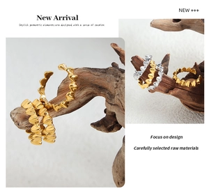 Macro detail of heart shaped rings in gold and silver finish on a rustic wood branch