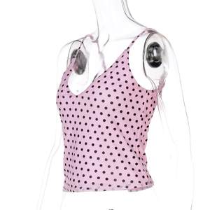 Close-up of pink polka dot crop top with V-neckline on a female mannequin model