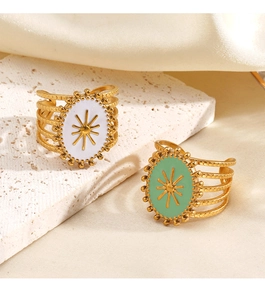 Detail of vintage sunburst oval rings with colorful enamel on layered gold bands